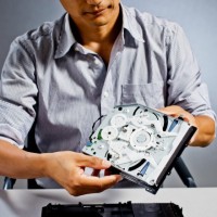 Ootori holds the console's optical drive, which plays DVDs and Blu-ray discs.