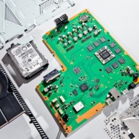 A closeup of the green motherboard. The central processor is the big square on the right, surrounded by eight memory chips. The other eight memory chips are on the other side of the board.