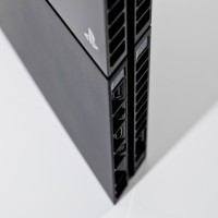 The rear of the PS4, where you'll find an AUX port (for a PS Camera), an HDMI out port (for TVs and other audio-visual devices), an optical digital audio out port (for audio devices), and a LAN port (for connecting to a network).